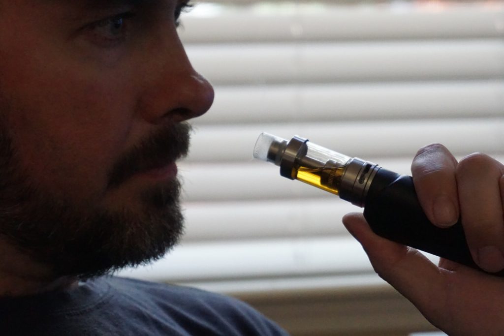 Vaper using e cigarette device indoors 31