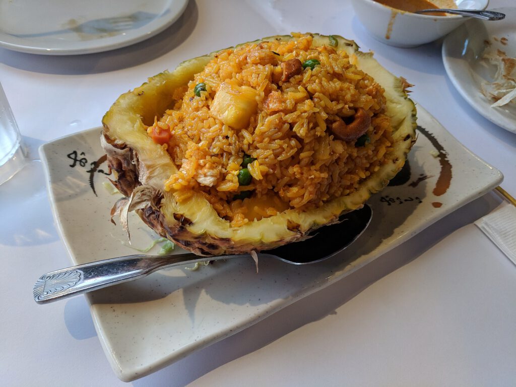Crab spring onion fried rice in a wok with spring onions and crab meat