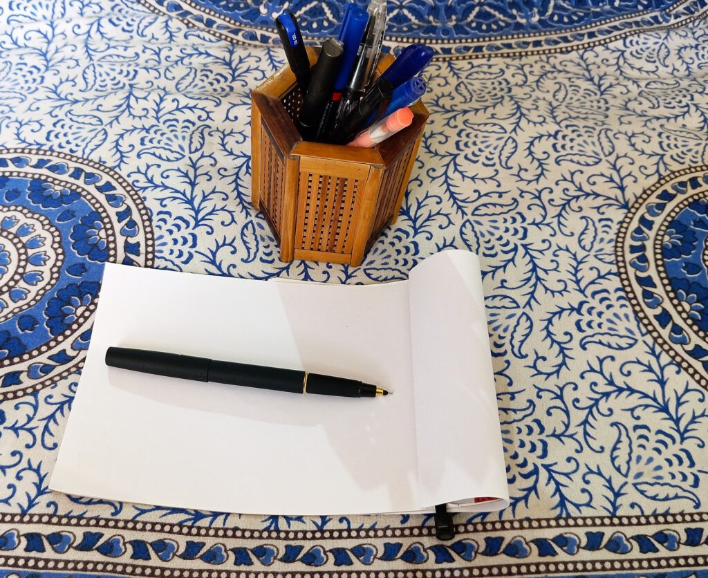 A printed Guardian cryptic crossword puzzle grid on a wooden table