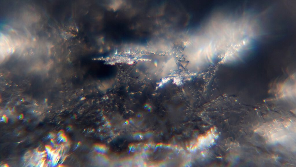 Snow crystals glittering in strong direct sunlight 42   wide crop   high contrast