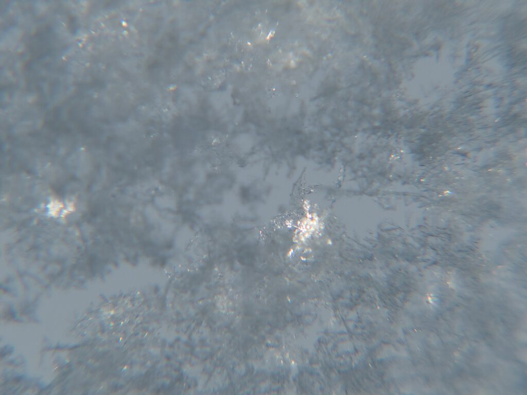 Snow crystals on window glittering in strong direct sunlight 34