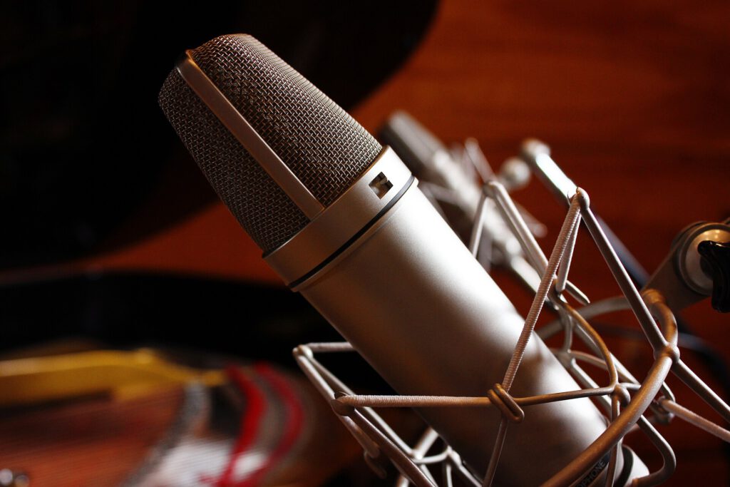 Japan Actors Union Proposes Strict AI Rules for Deceased Performers Microphone and script on a desk representing ai voice acting regulations