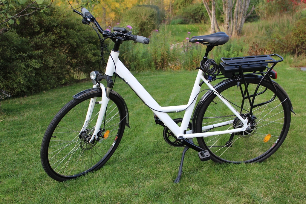 Electric bicycle parked on sidewalk near hospital entrance