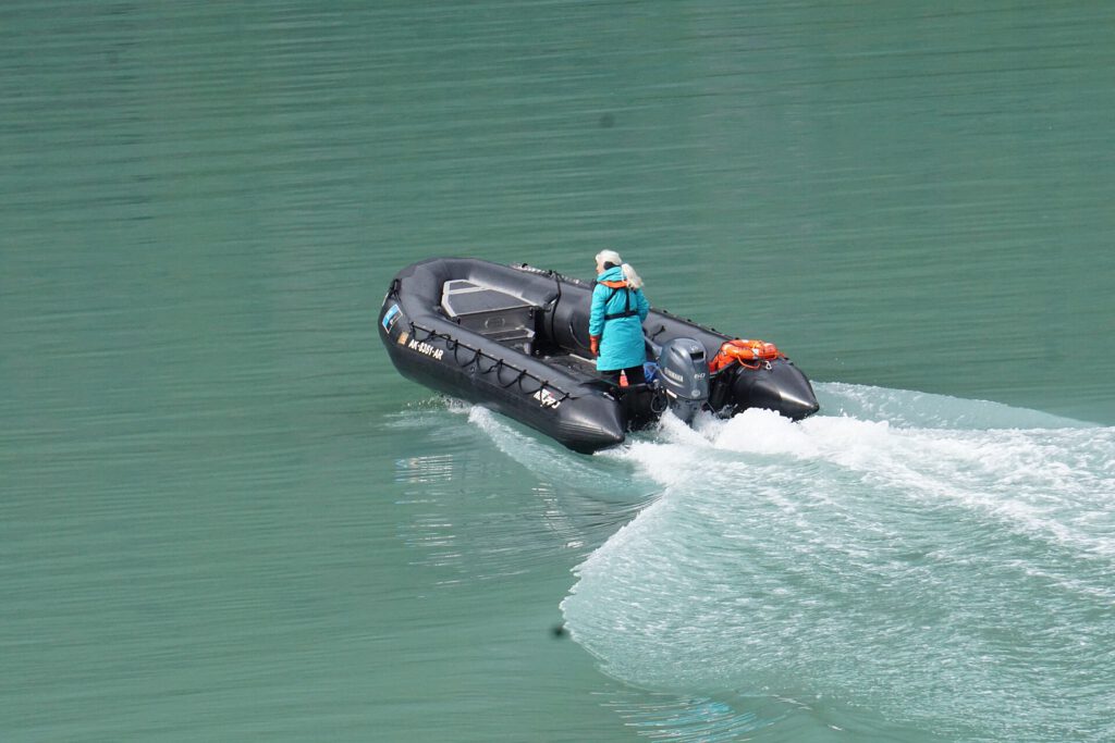 Naturalist from the Quest heads out in a Zodiac to get some pictures 396