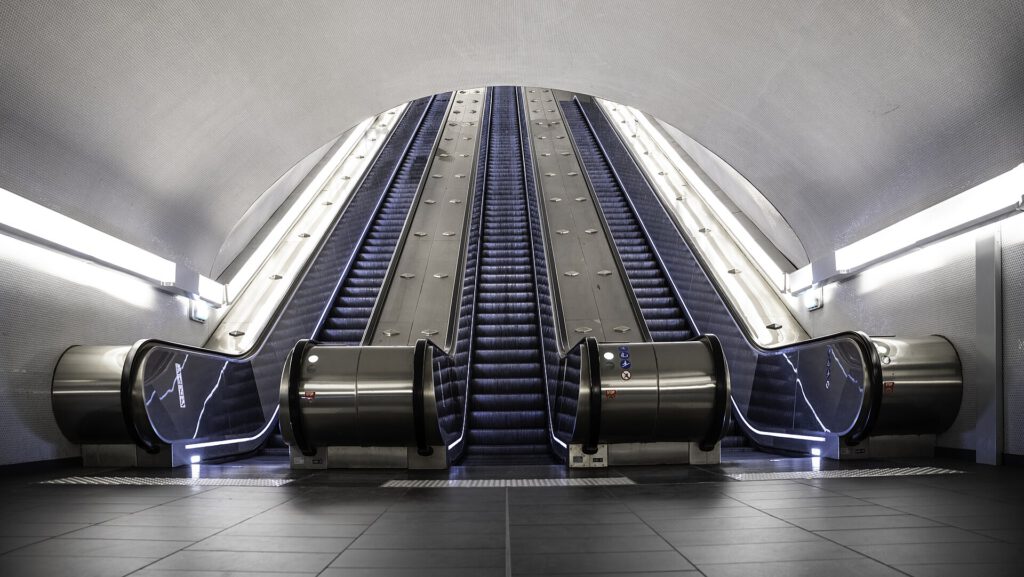 How a London Tube Incident Changed a Woman's Life 3 Escalators at Auber RER station in Paris, recently renovated, with clean and modern underground architecture