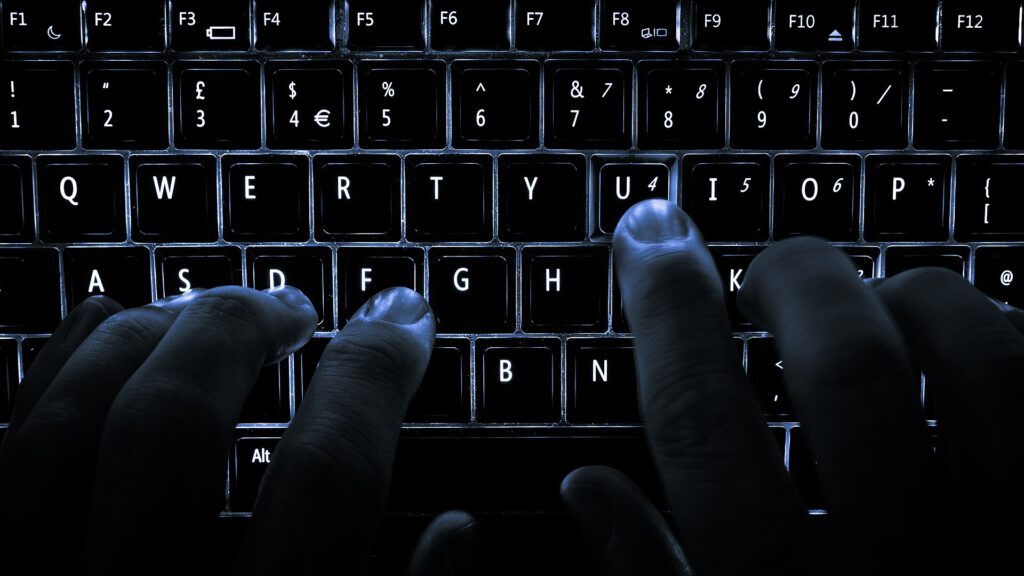 Laptop screen displaying code editor interface with warning icon for malicious claude extension