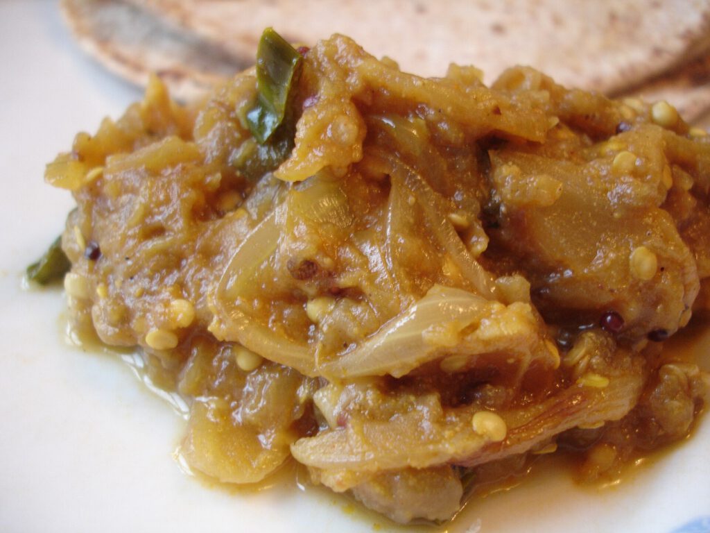 Indian Chef Maunika Gowardhan Shares Two Coconut Curry Recipes Spicy aubergine baingan coconut curry in a bowl