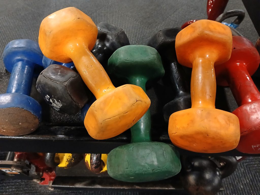 Colorful pile of dumbbells at the gym