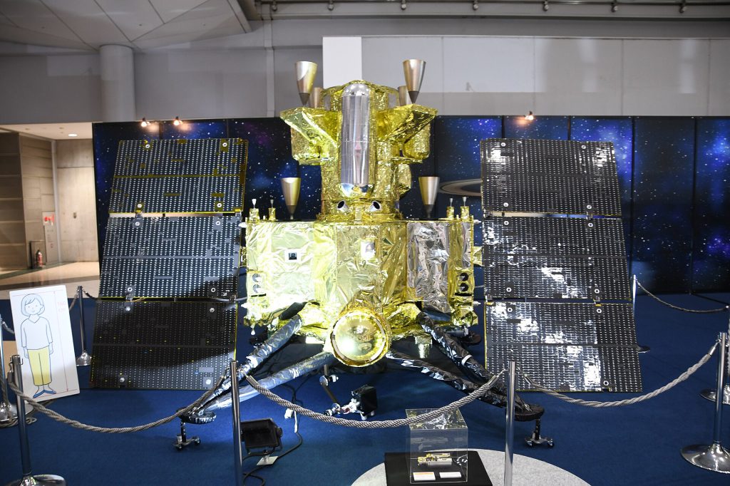 MMX spacecraft (scale model) behind view in 1F atrium of JA2024 at Tokyo Big Sight October 19,