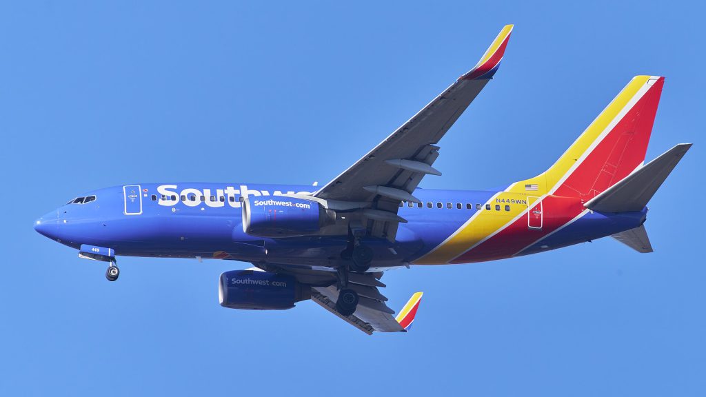 Southwest Airlines Outage Forces Manual Passenger Processing Southwest Airlines plane at gate during system outage