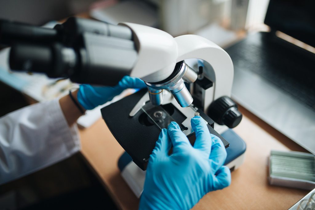 One Week of Strength Training Shrinks Fat Cells in Mice 3 Close up of a lab technitian adjusting a microscope glass slide