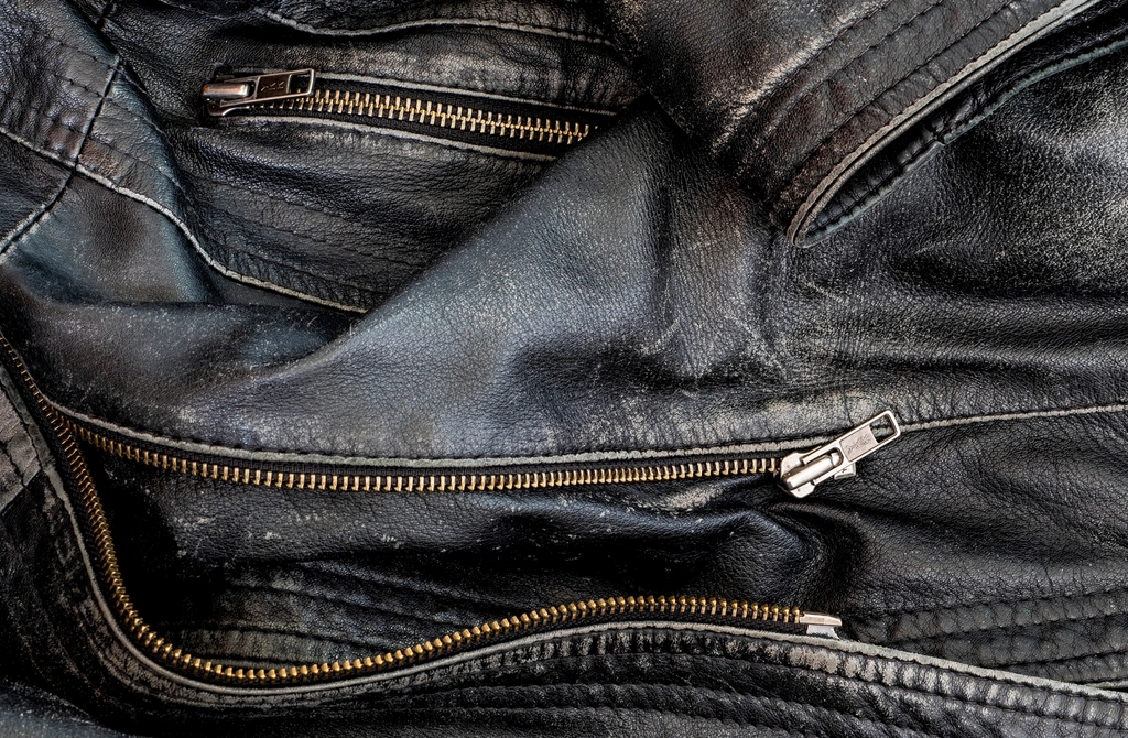 Black worn leather jacket detail