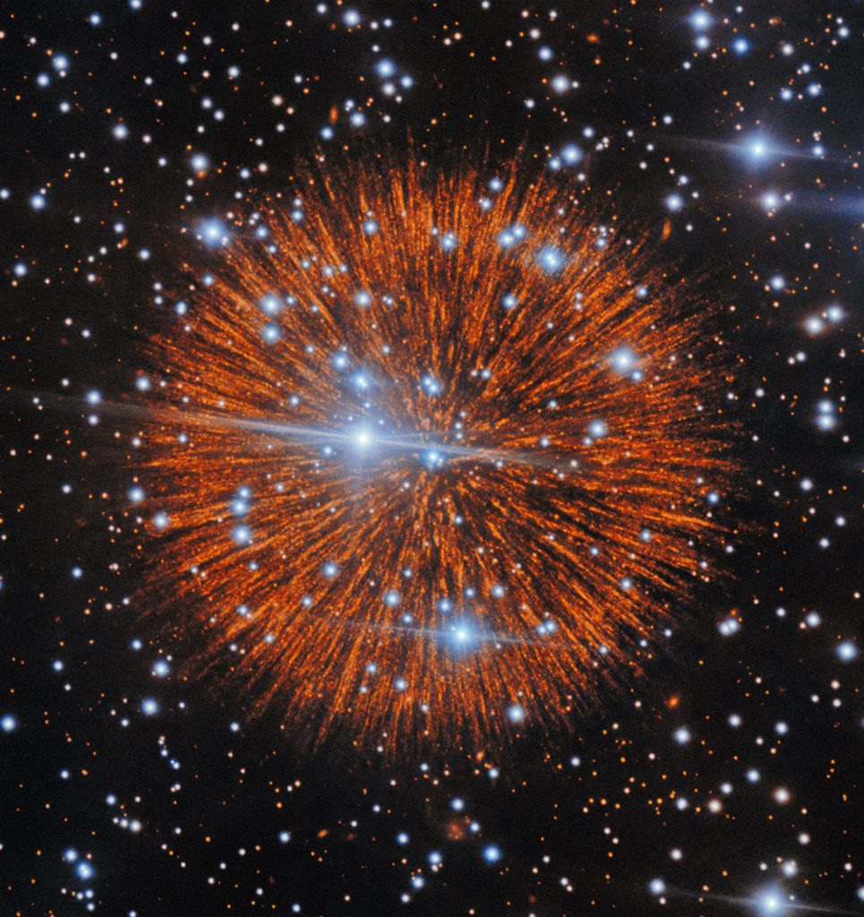 A red explosion extending radially like a firework over a dark field of stars.