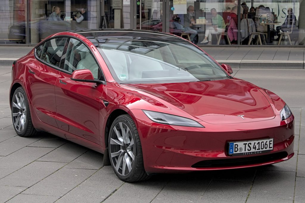 Tesla Expands Powershare Home Backup to Model 3 and Model Y Tesla Model 3 parked next to a Tesla Powerwall 3 battery unit for home backup power