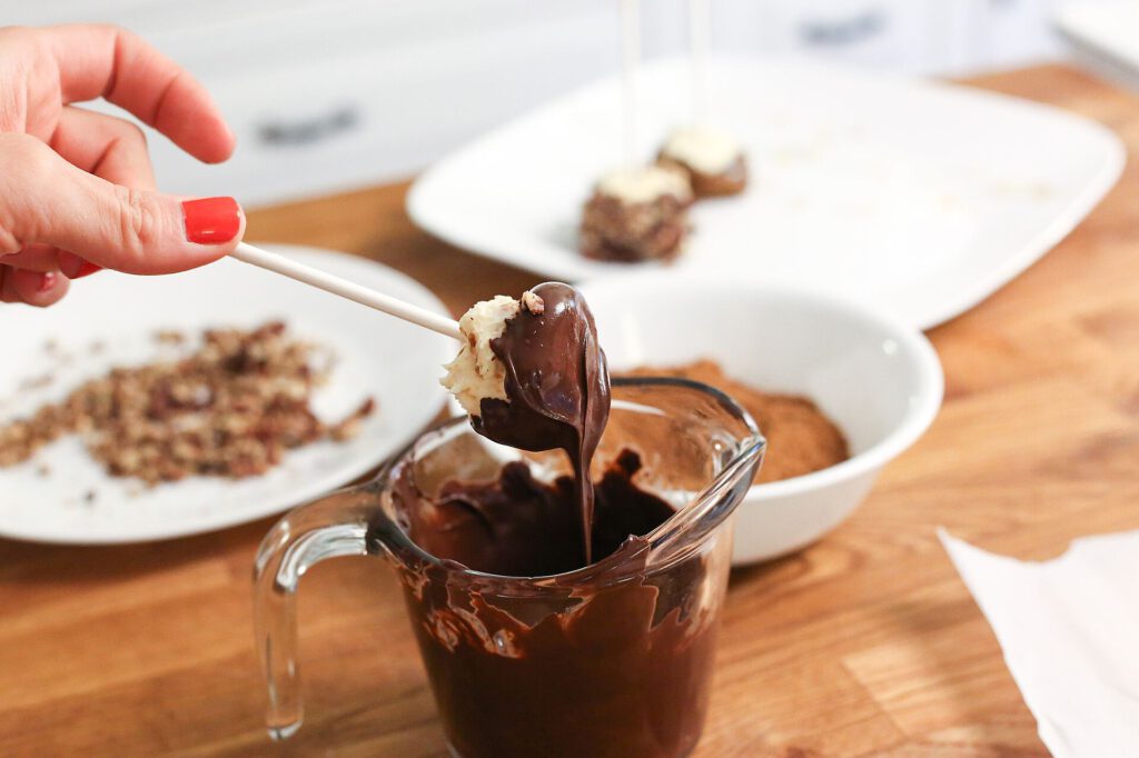 Thomasina Miers shares pumpkin fritters and chocolate cake recipes 3 Dipping pumpkin cheesecake cake pops in chocolate sauce