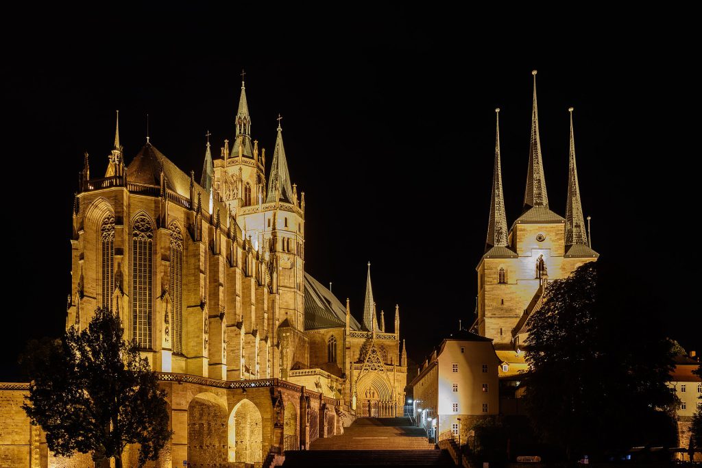 Medieval cathedral towers in Erfurt Germany with morning market stalls