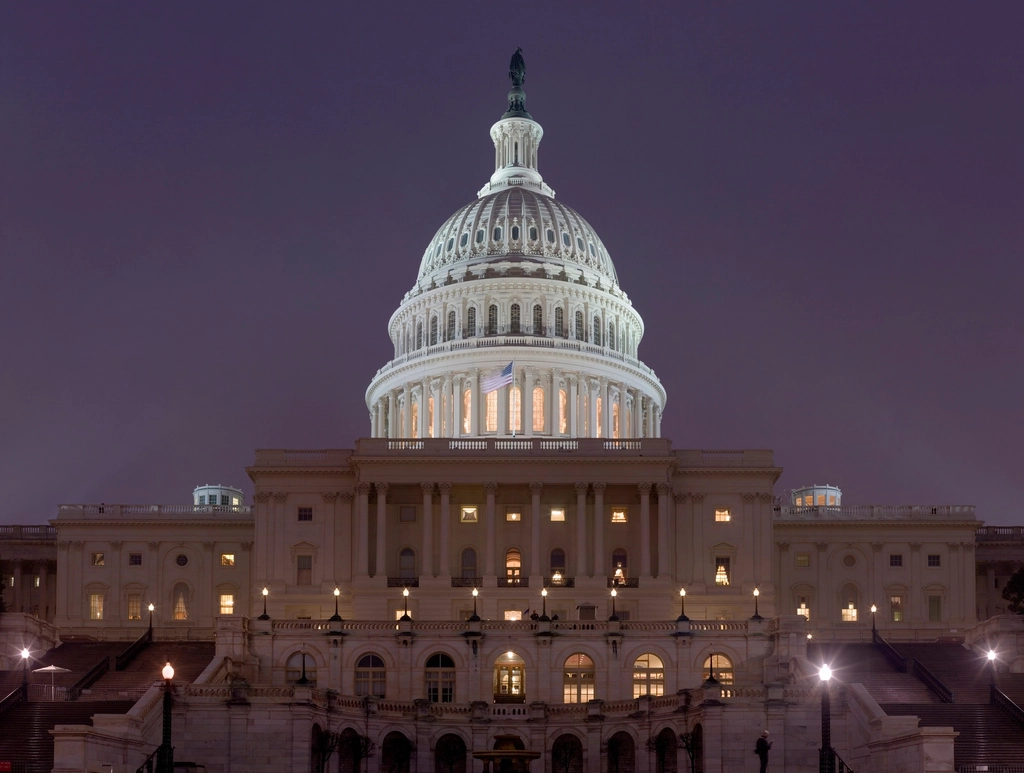 Trump Sanctions Waiver Draws Bipartisan Condemnation 2 US Capitol night. mosaic image