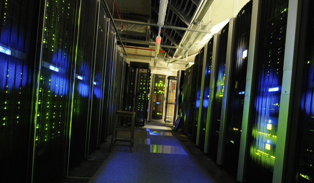 AI Firms Warn UK Has One Year to Win Public Trust on Datacentres Exterior view of a large modern datacentre facility in the UK with server racks visible