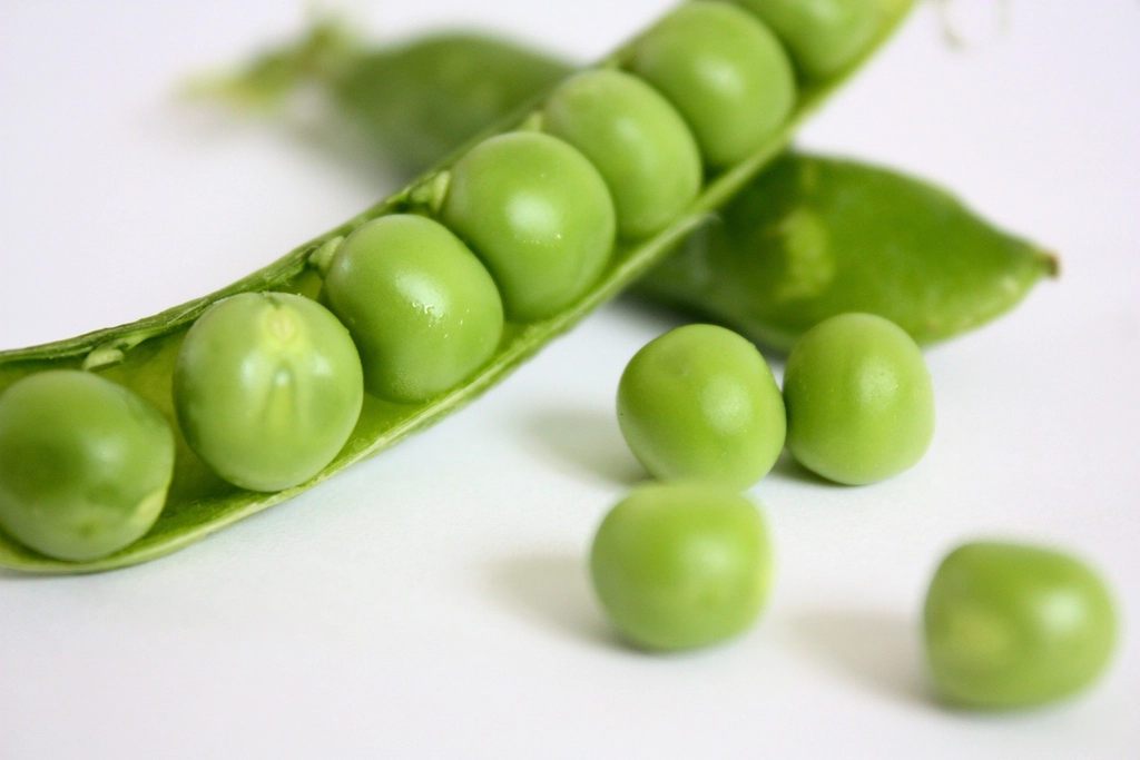 UK Pea Consumption Hits 50-Year Low as Chefs Push New Recipes Fresh green peas in a pod on a wooden table
