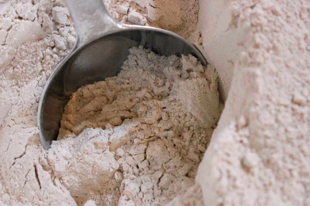 Whole wheat grain flour being scooped