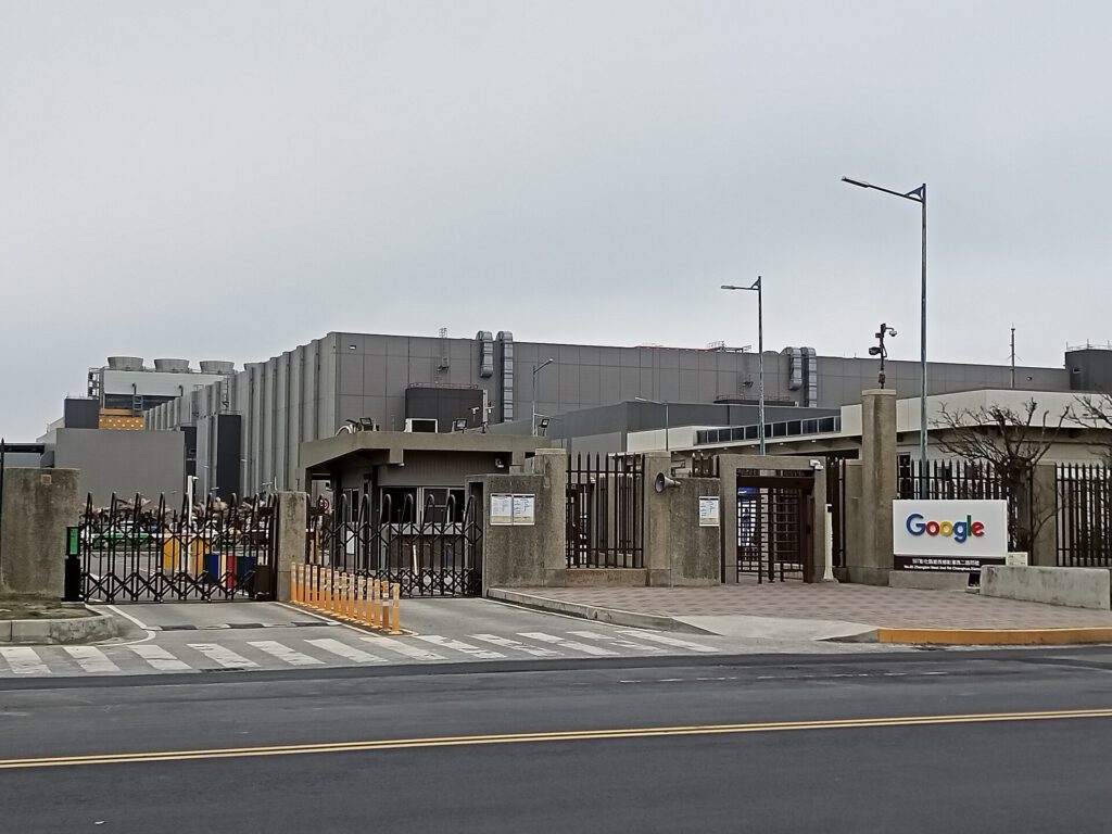 Data Center Backlash Grows Ahead of US Midterms Large industrial data center building exterior with server racks visible