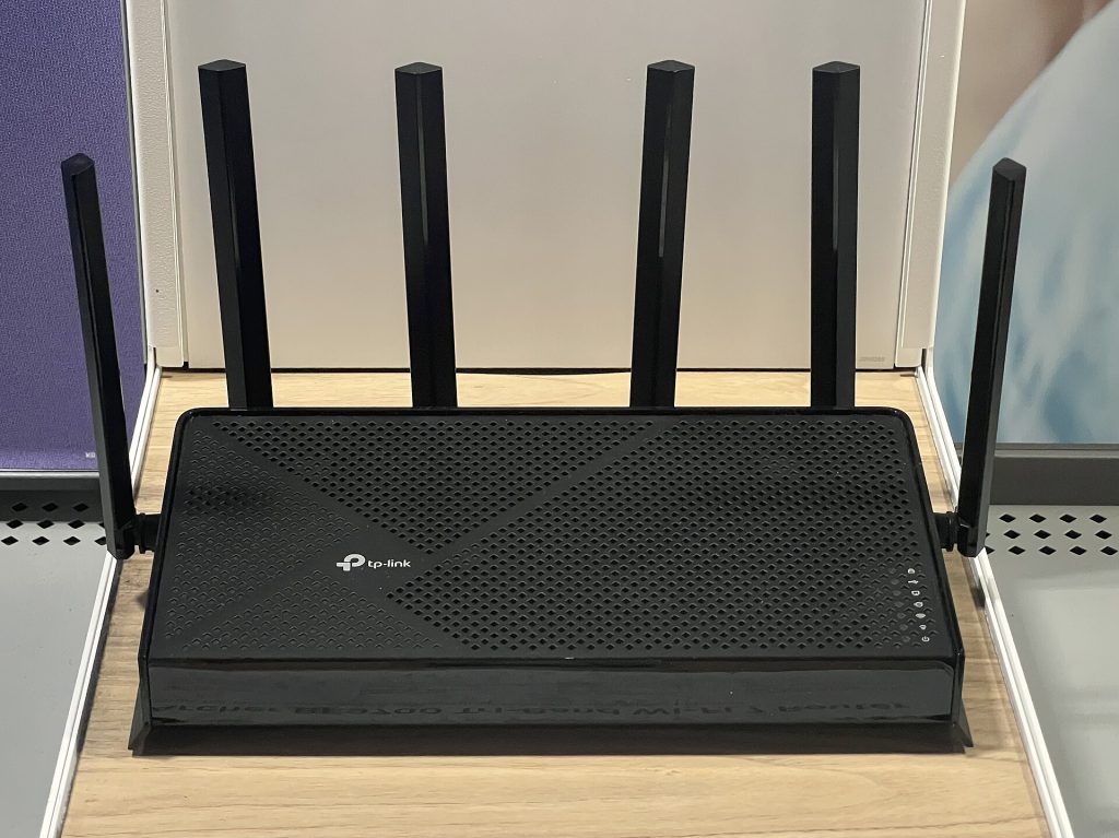 Modern Wi-Fi 7 router placed on an open shelf away from walls