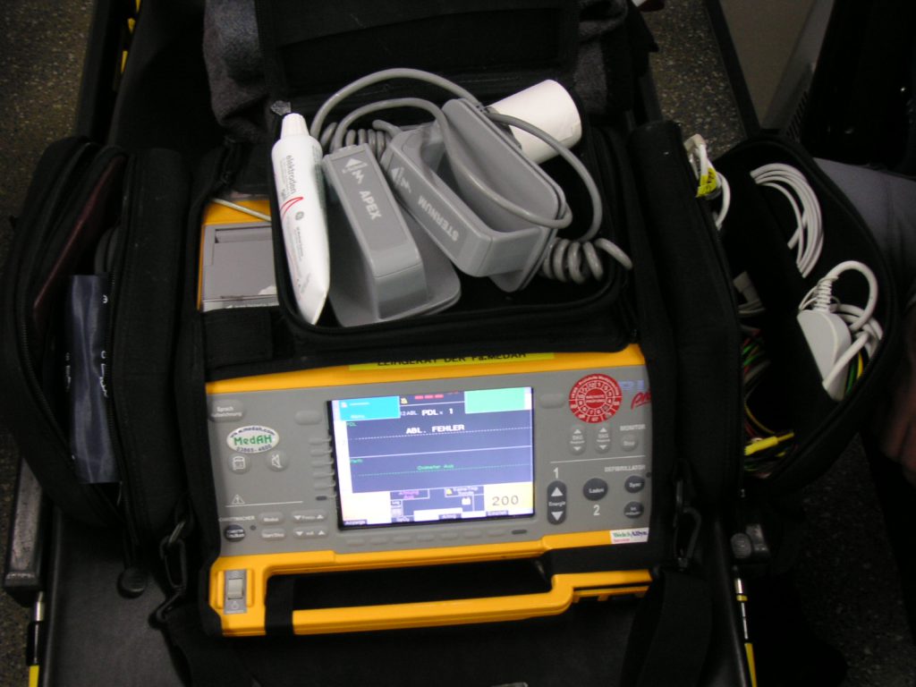 Woman Survives Cardiac Arrest After Being Clinically Dead for 10 Minutes Medical defibrillator pads on a hospital bed representing cardiac arrest survivor treatment